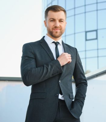 Portrait of a smiling businessman in a modern business environment.